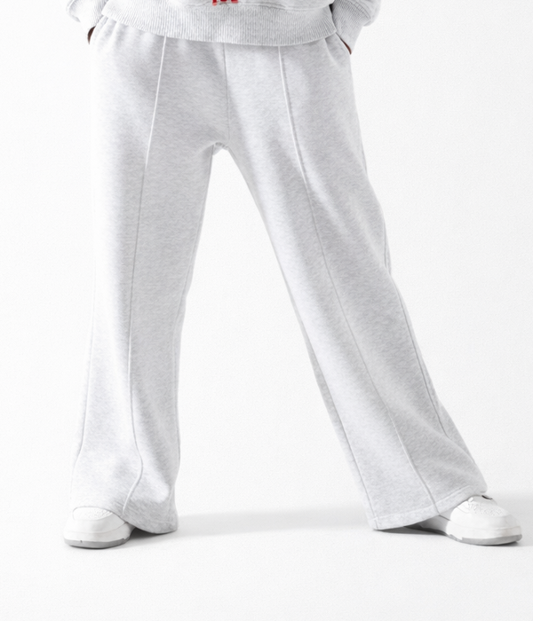 Gray sweatpants worn by a person on a white background